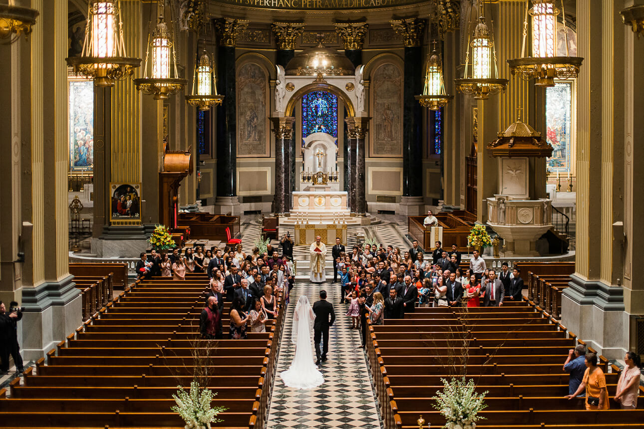 bride with long veil walking down the aisle at The Cathedral Basilica of Saints and Paul in Philadelphia