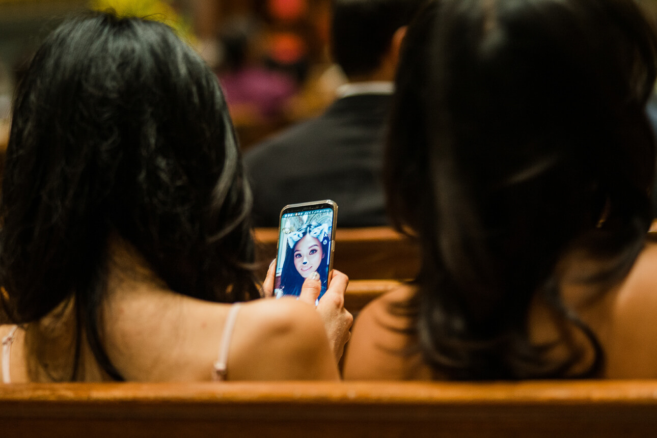 wedding guests playing with their phones